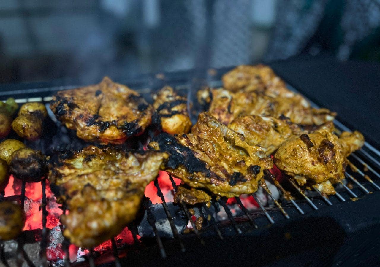 chicken being cooked on BBQ amenity at Vandana Villa